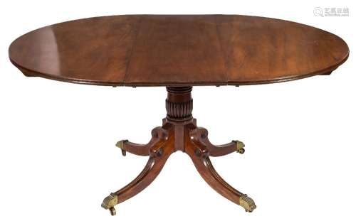 A mahogany circular extending dining table in the Regency taste:,