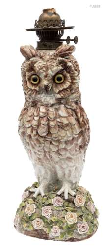 A large Whittmann & Roth 'owl' oil lamp: with glass eyes and on mound base applied with roses and