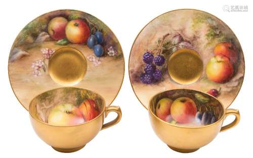 A pair of Royal Worcester fruit painted cabinet cups and saucers: painted respectively with apples,