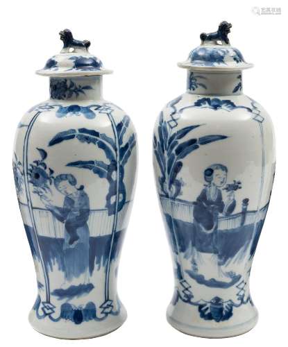 A pair of Chinese blue and white baluster vases and covers: with lion dog finials,