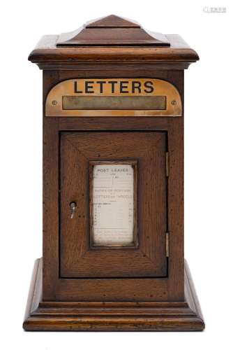 A late Victorian/Edwardian oak domestic letter box: with stepped domed top,