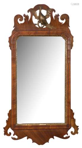 A Georgian mahogany and partly gilt fret cut mirror:, with pierced Ho-ho bird cresting,