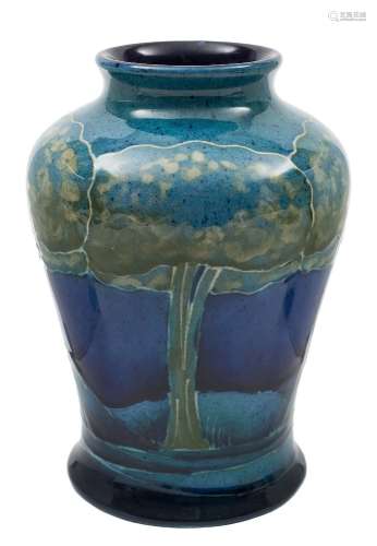 A Moorcroft 'Moonlit Blue' baluster vase: decorated and tube lined in blue and green with tall
