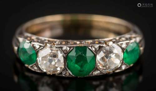 An emerald and diamond five-stone ring: with graduated oval emeralds between old brilliant-cut