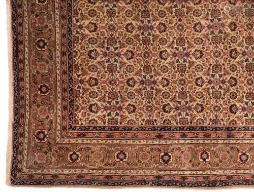 A Sivas carpet:, the beige field with an all over geometric palmette, medallion and leaf design,