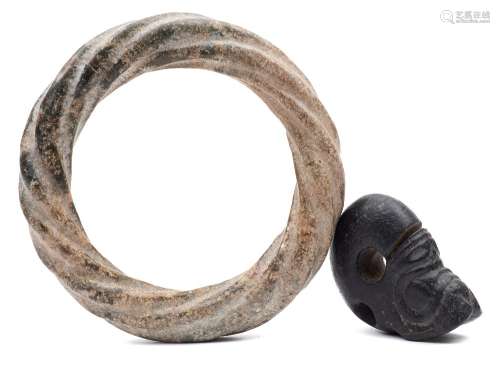 A Chinese archaic-style calcified jade bangle and a black jade pendant: the ring carved as a