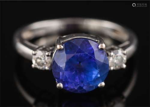 A modern tanzanite and diamond ring: the round tanzanite approximately 8.7mm diameter x 6.