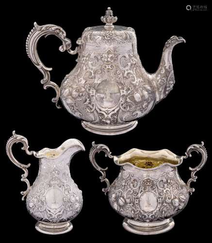 A Victorian silver three-piece tea service, maker Robert Hennell III, London, 1861: crested,