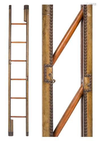 An olive green leather mounted and brass studded pole ladder:, with six rungs,