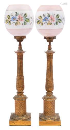 A pair of 19th century French gilt metal table lamps: on reeded and acanthus decorated columns,