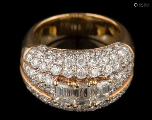 A diamond mounted domed cluster ring: the three principal, baguette-cut diamonds approximately 0.