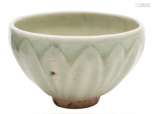 A small Chinese celadon bowl: the exterior moulded with lotus leaves, probably Song Dynasty,