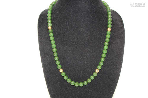 Chinese spinach jade bead necklace with 14 k gold clasp.