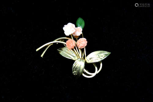 A coral and jade flower pendant