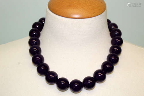 A purple glass beads necklace.