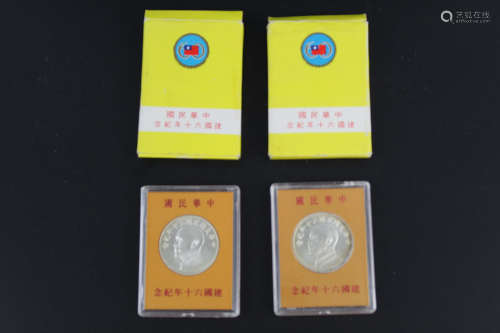 Two silver Chinese coins in commemoration of 60th anniversary of the founding of the Republic of China.