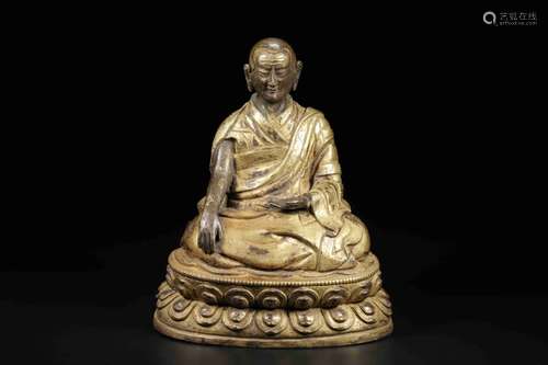 A GILT-BRONZE FIGURE OF LAMA