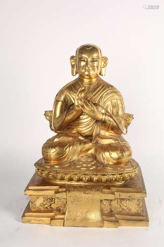 A GILT-BRONZE FIGURE OF LAMA