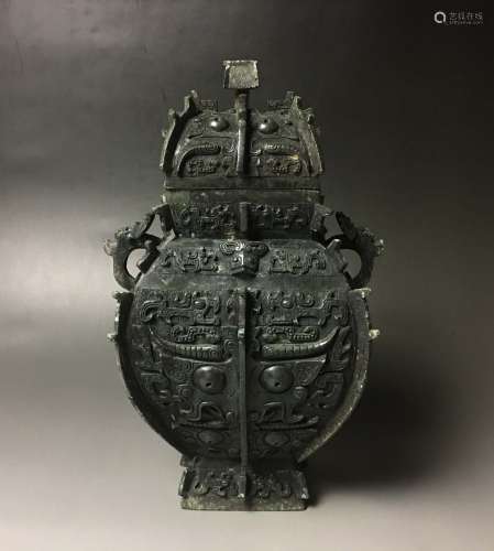 An Archaic Bronze Ritual Wine Vessel and Cover