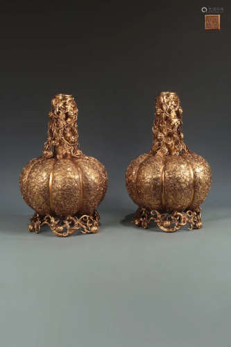 A PAIR OF GILT BRONZE MELON DESIGN CANDLE HOLDERS