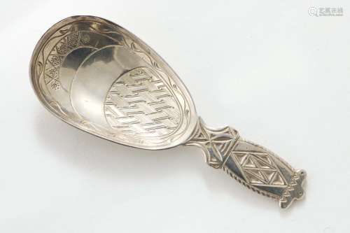 An arts & crafts caddy spoon