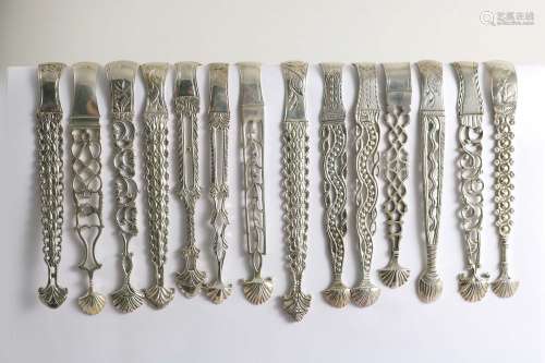 Cast & pierced arms:-fourteen various pairs of george iii sugar tongs (some