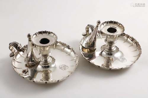 A pair of old sheffield plated circular chambersticks