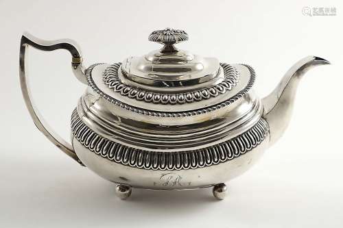 A george iii tea potof rounded oblong form on ball feet, decorated with moulded