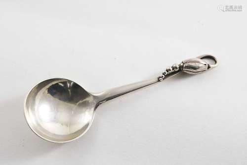 An early 20th century danish blossom pattern caddy or jam spoon with a circular