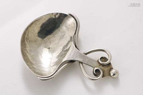 An arts & crafts caddy spoon