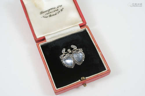 A victorian moonstone and diamond double heart brooch