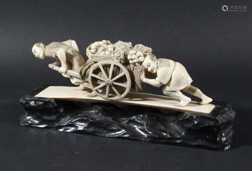 Japanese ivory okimono,meiji, carved as a man pulling a vegetable cart another