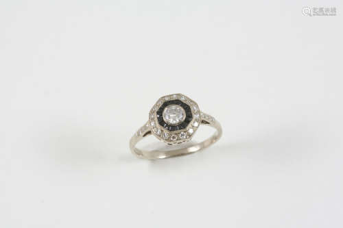 A black onyx and diamond cluster ring