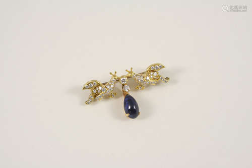 A diamond and sapphire bird brooch