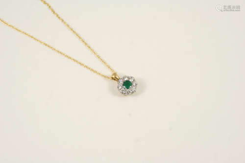 An emerald and diamond cluster pendant