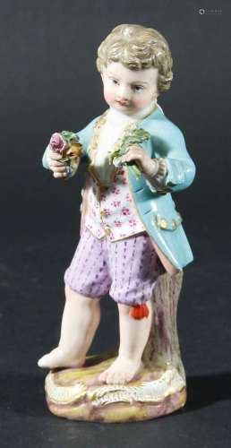 Meissen figure of a boy,19th century, standing holding posies of flowers, blue