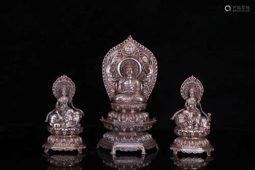 SET OF THREE SILVER MOLDED BUDDHA STATUES