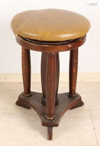 Antique piano stool with four columns. Adjustable.