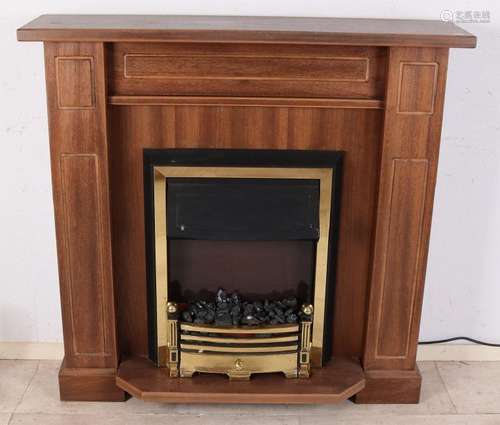 Tropical wood fireplace surround with brass. With metal