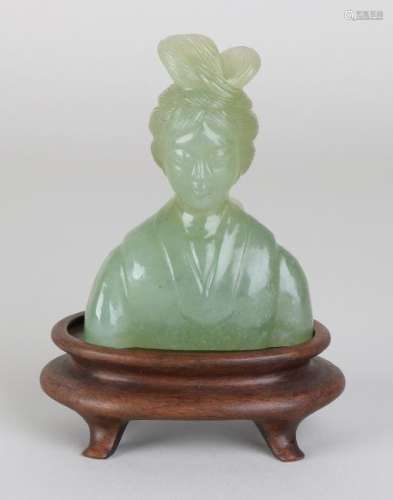 Old Chinese jade woman bust on wood-stoned pedestal.