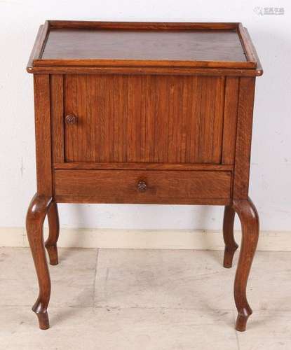 Antique oak side table with drawer and rolling door.