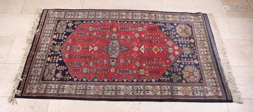 Old Persian rug in the colors black / red / cream,