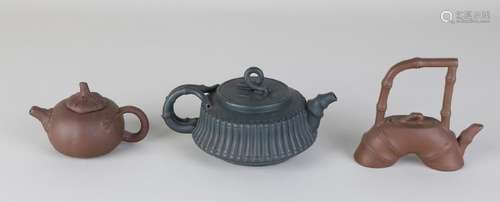 Three old Yixing Chinese teapots, diverse. With soil