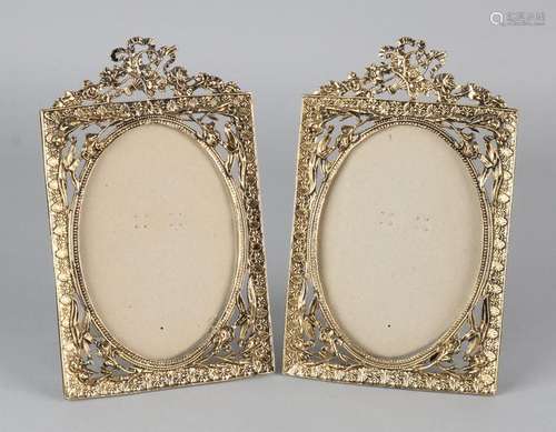 Two decorative brass photo frames in Louis Seize style.