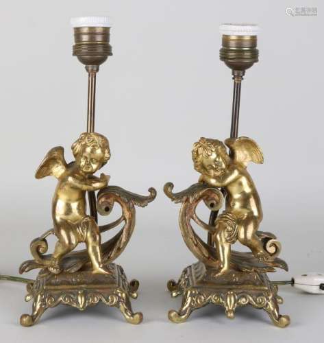 Two antique bronze table lamps with putti. Circa 1920.