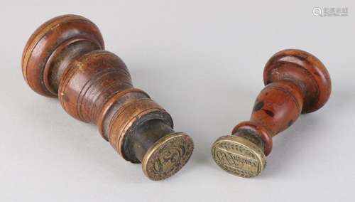 Two 19th century walnut painted stamps with brass and