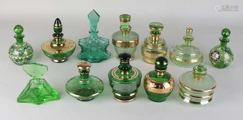 Twelve times various green glass vials with gold rim.