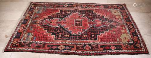 Large old Persian hand knotted rug in earth tones,