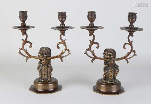 Two antique Amsterdam bronze candlesticks with lions.