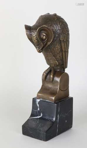 Bronze Art Deco style owl. On black marble basement.